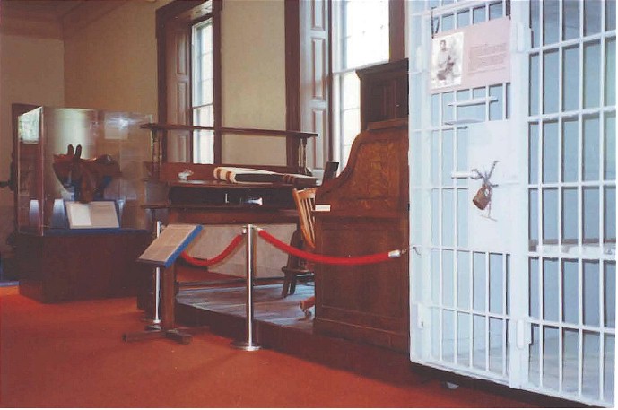 Belle Starr's Saddle, U.S. Marshals Office ledger book, desk and jail cell