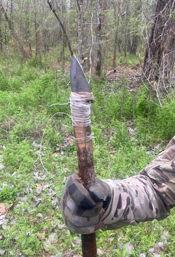 Brian Shaller holding a knife attached to a stick 