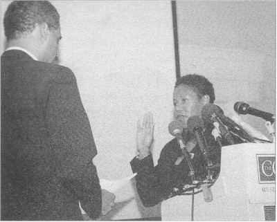 Former Deputy Attorney General Eric Holder swears in Ruby Bridges as an honorary deputy marshal at the Corcoran Gallery of Art in Washington, D. C.