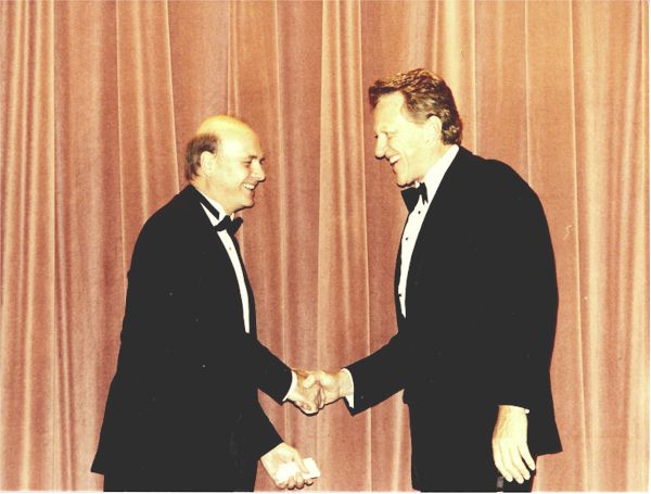 U.S. Marshals Service Director Stan Morris shaking hands with Mr. Arness