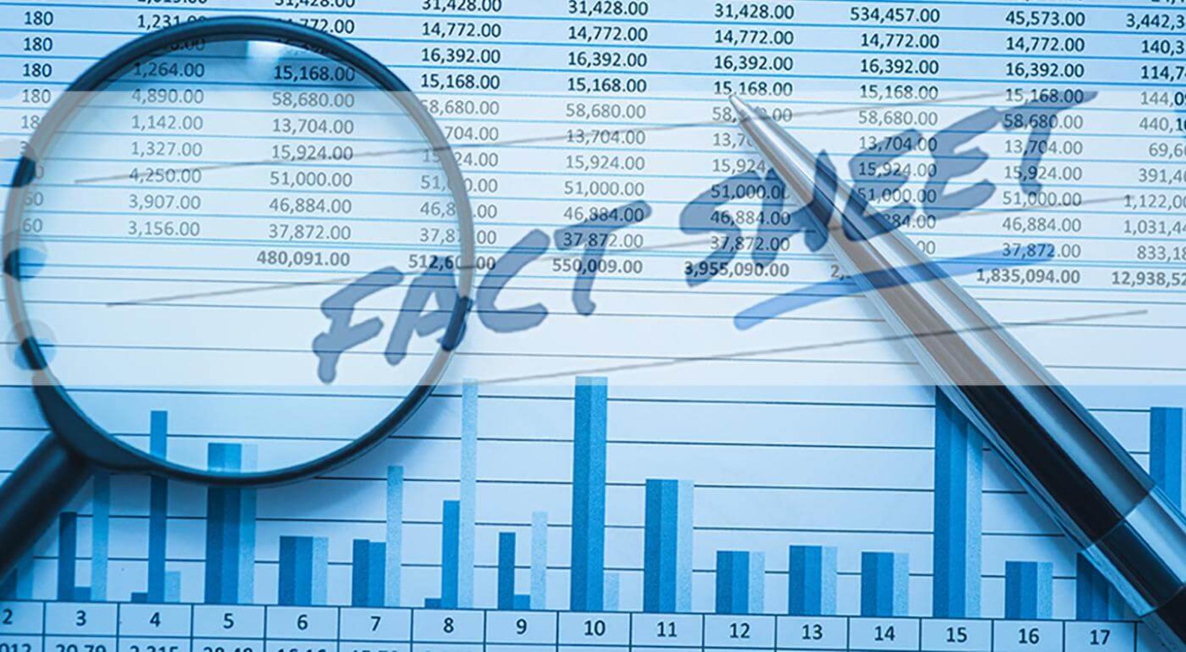 A pen on factsheet with a magnifier