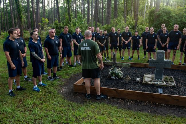 Deputy U.S. Marshals at grave site of Bucky E. Burke