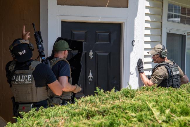 Deputy U.S. Marshals at a residence during Operation North…