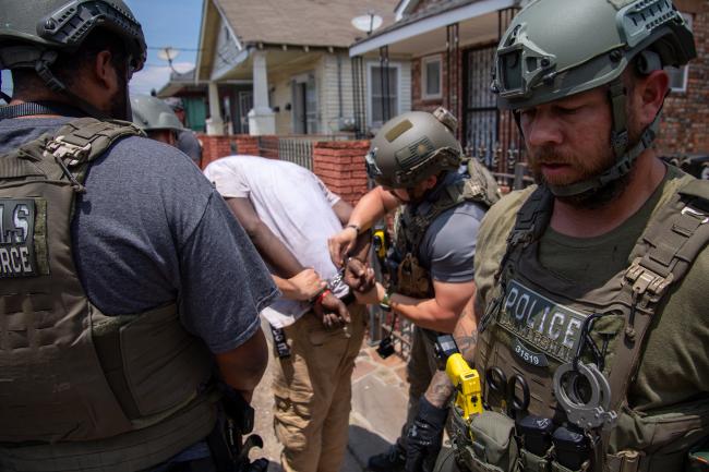 Deputy U.S. Marshals with captured fugitive during…