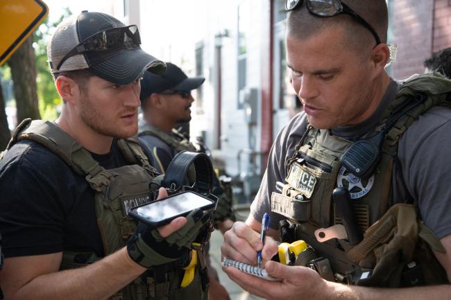 Deputy U.S. Marshals writing report of Operation North Star.