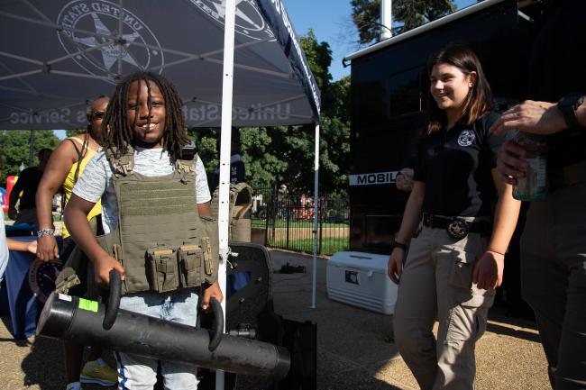 Deputy U.S. Marshals talks with child during the 2022…