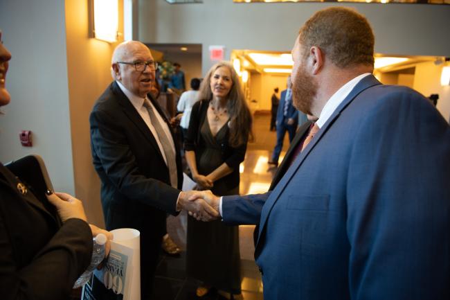 Herschel Garner shaking hands with a man.