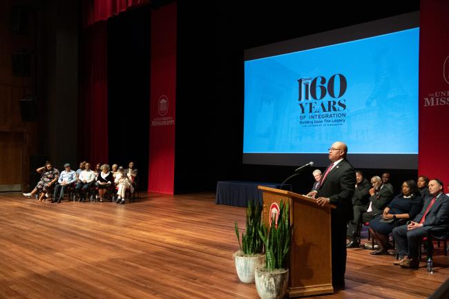 Director Davis speaking to audience at the University of…